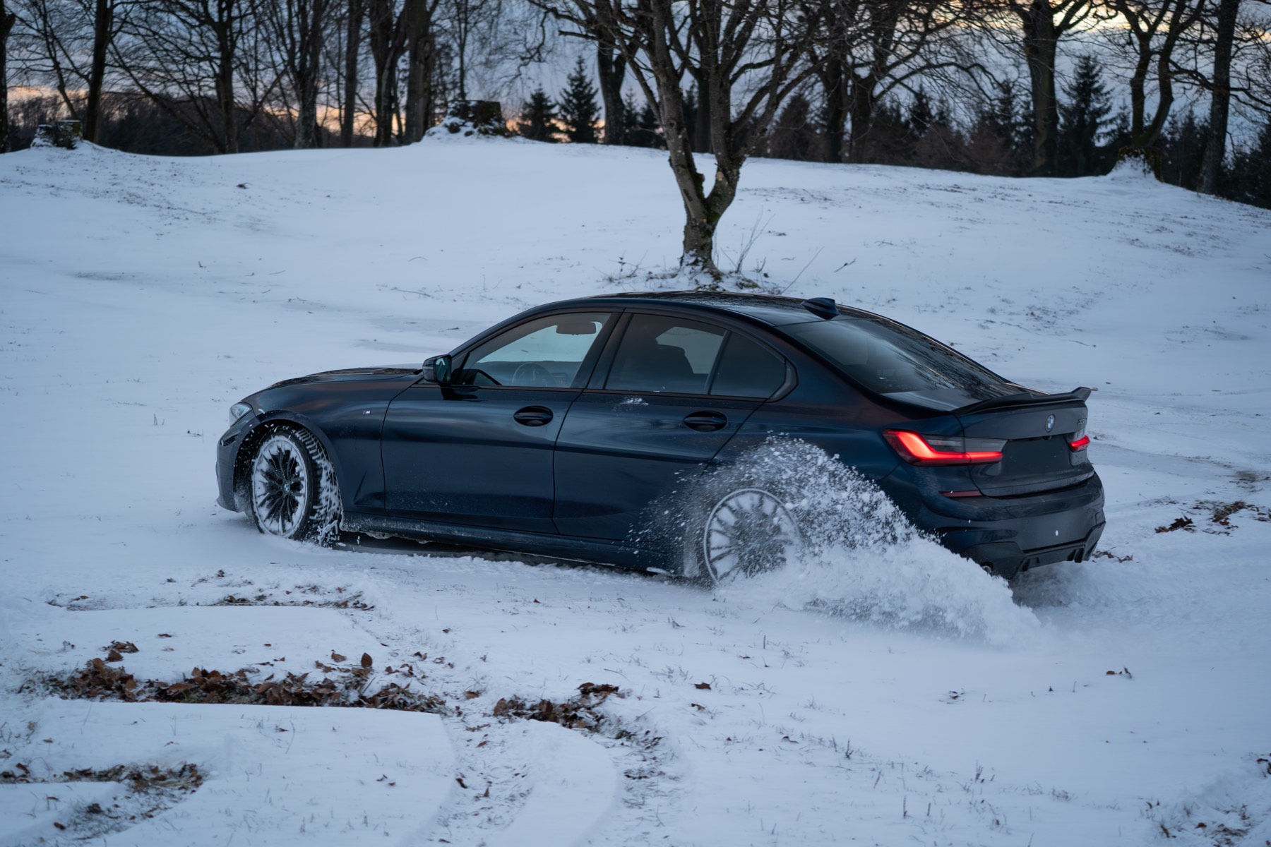 BMW G20 in Tansanitblau im Drift auf einer verschneiten Fläche